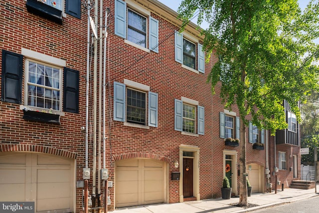 exterior space featuring brick siding and an attached garage