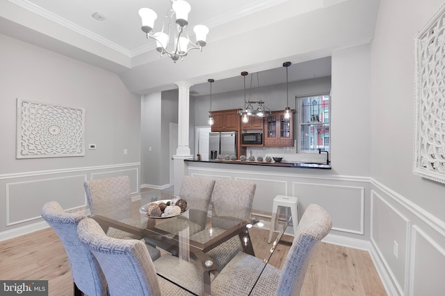 903 R St NW Unit 1, Washington, DC 20001 - dining area with light wood finished floors, a notable chandelier, ornamental molding, a decorative wall, and ornate columns