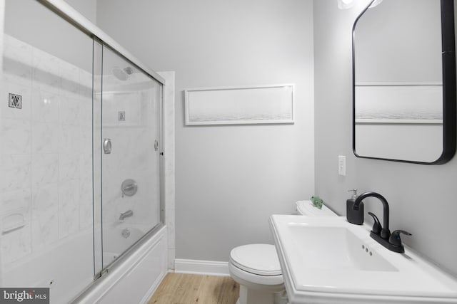 903 R St NW Unit 1, Washington, DC 20001 - full bath featuring wood finished floors, a sink, baseboards, combined bath / shower with glass door, and toilet