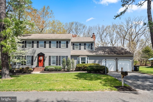 22 Cochise Cir, Medford Lakes, NJ 08055 - colonial home featuring driveway, a chimney, a front lawn, and a garage