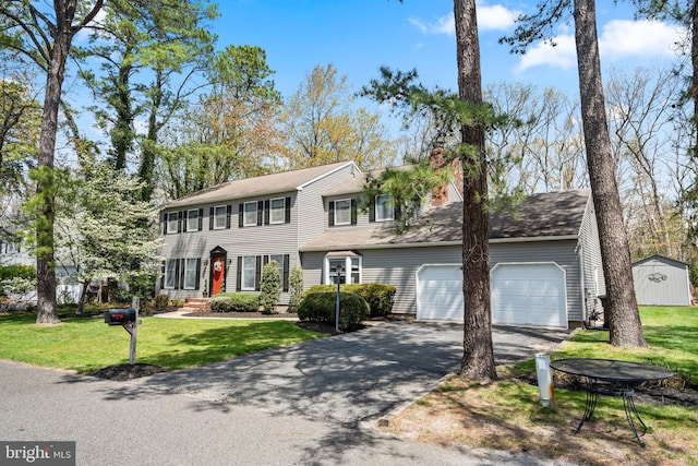 22 Cochise Cir, Medford Lakes, NJ 08055 - colonial house with a chimney, an attached garage, aphalt driveway, and a front yard