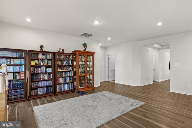 interior space featuring baseboards, recessed lighting, visible vents, and wood finished floors