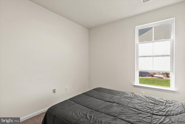 bedroom with carpet flooring and baseboards