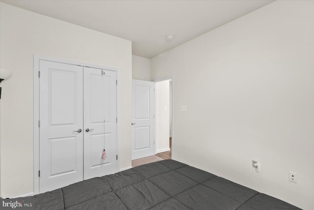 unfurnished bedroom featuring a closet and baseboards