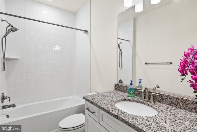 full bath featuring toilet, vanity, and washtub / shower combination