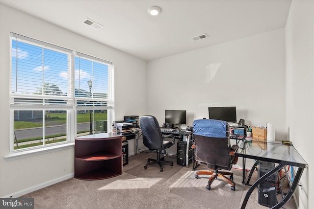 carpeted home office featuring visible vents and baseboards