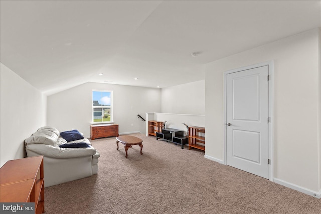 carpeted living room featuring vaulted ceiling and baseboards