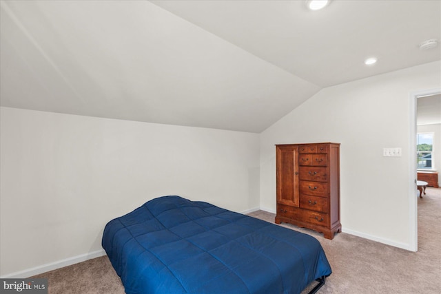 bedroom with lofted ceiling, light carpet, baseboards, and recessed lighting