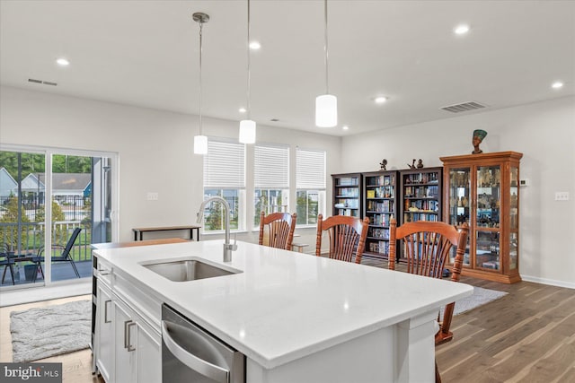 kitchen with a sink, light wood-type flooring, stainless steel dishwasher, visible vents, and recessed lighting