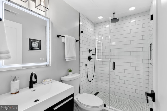 bathroom with visible vents, a shower stall, vanity, toilet, and recessed lighting
