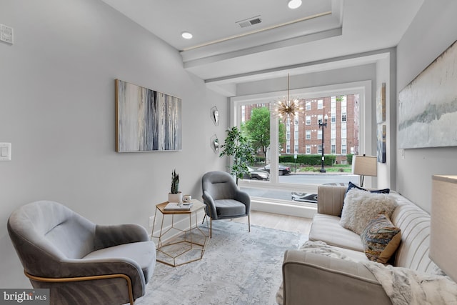 living area featuring a chandelier, visible vents, wood finished floors, and recessed lighting
