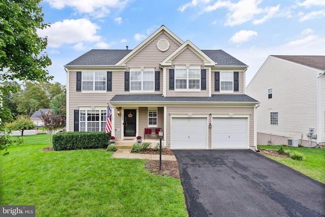 view of front of home with a garage, central AC, a front lawn, and aphalt driveway