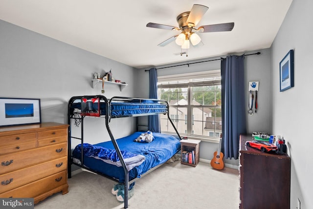 carpeted bedroom with a ceiling fan and baseboards