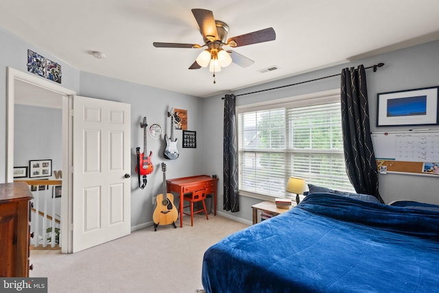 carpeted bedroom with baseboards, ceiling fan, and visible vents
