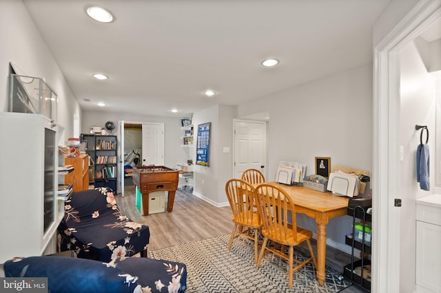 dining space with baseboards, recessed lighting, and light wood finished floors