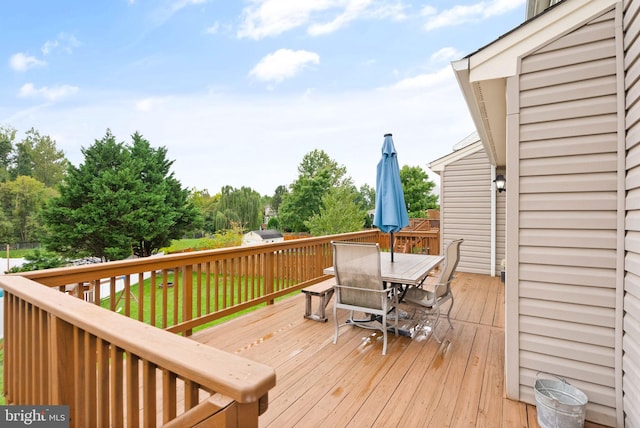 wooden terrace with outdoor dining area