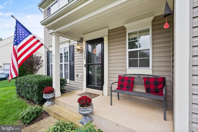 view of exterior entry featuring a porch