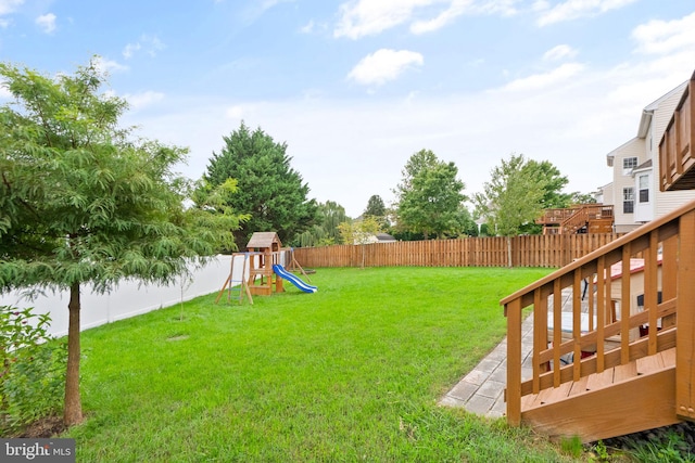 view of yard featuring a fenced backyard and a playground