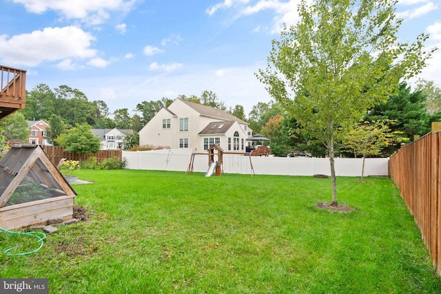 view of yard with a playground and a fenced backyard