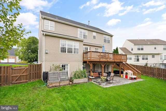 back of house featuring a lawn, a wooden deck, a patio area, stairway, and a fenced backyard