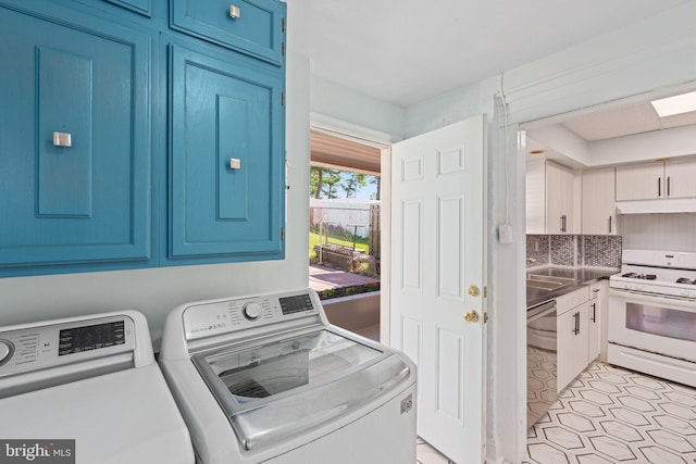 washroom with separate washer and dryer and cabinet space