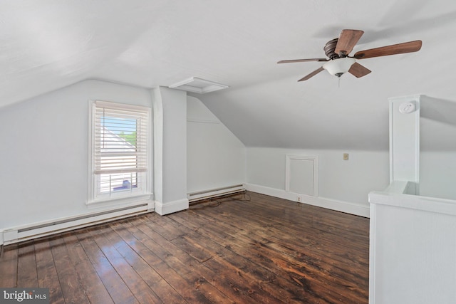 additional living space featuring baseboard heating, hardwood / wood-style floors, vaulted ceiling, a ceiling fan, and baseboards