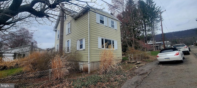 view of side of property featuring aphalt driveway