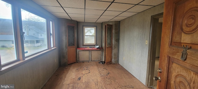 hallway with a paneled ceiling