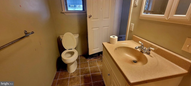 bathroom featuring toilet, tile patterned flooring, and vanity