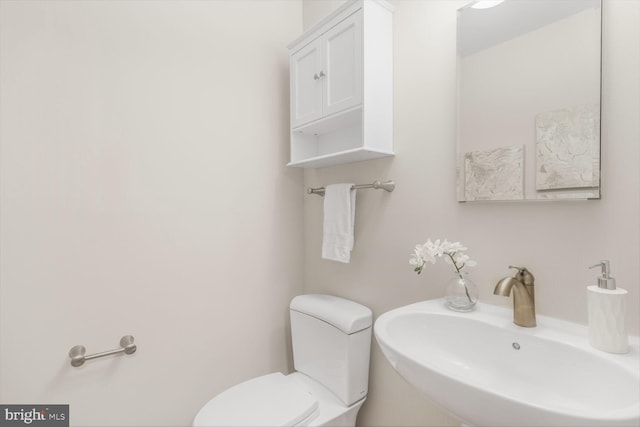 half bathroom with a sink and toilet