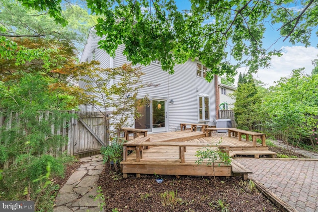 wooden deck featuring central air condition unit, a gate, and fence