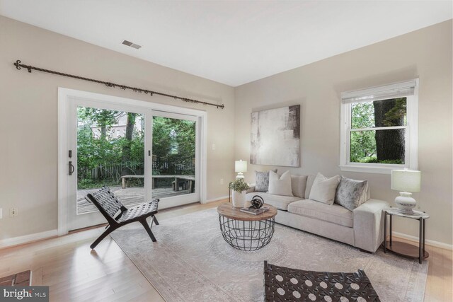 living area with light wood finished floors and baseboards
