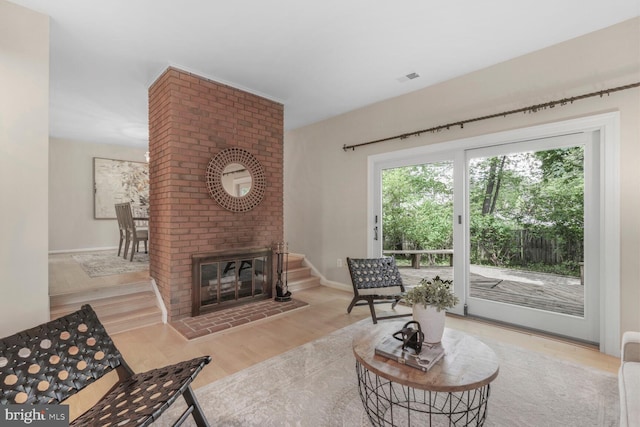 sitting room featuring wood finished floors, baseboards, and a fireplace