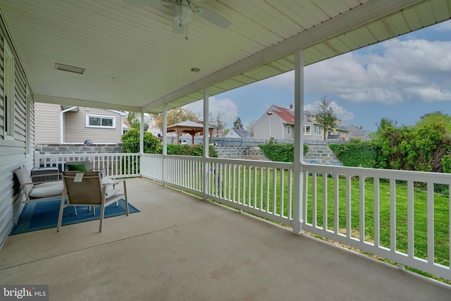 view of patio with a residential view and ceiling fan