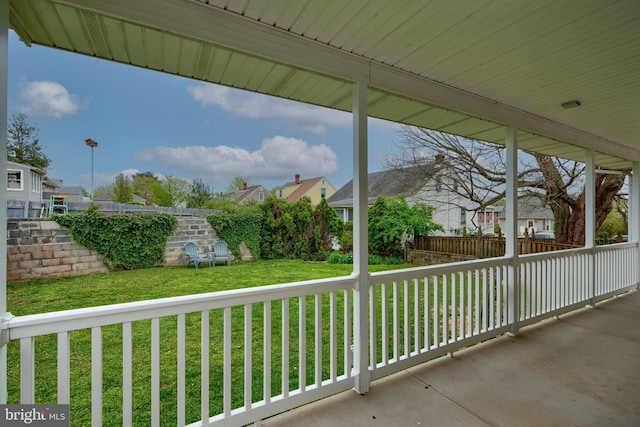view of patio / terrace with a residential view and fence