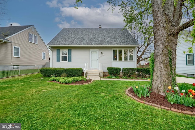 cape cod home with a front lawn, roof with shingles, and fence