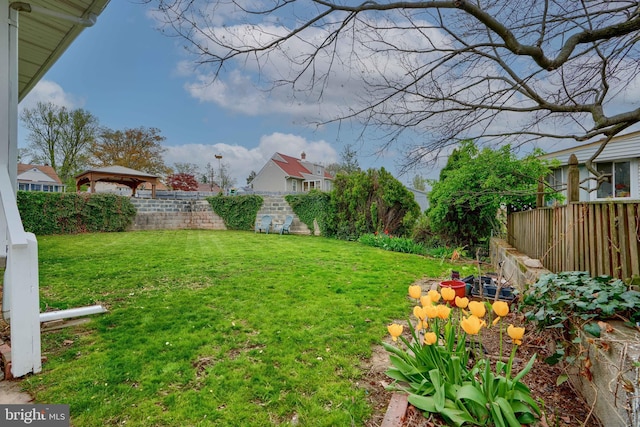 view of yard featuring a fenced backyard and a gazebo