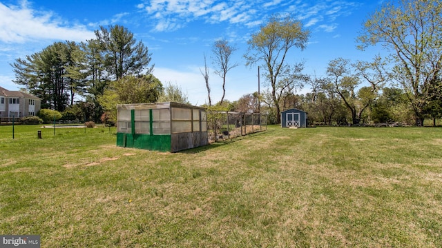 view of yard featuring an outbuilding, an exterior structure, and a storage unit
