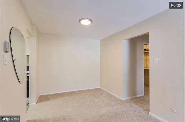 unfurnished room featuring carpet floors and baseboards