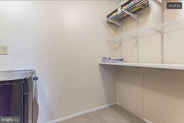 walk in closet featuring carpet flooring and washer and clothes dryer
