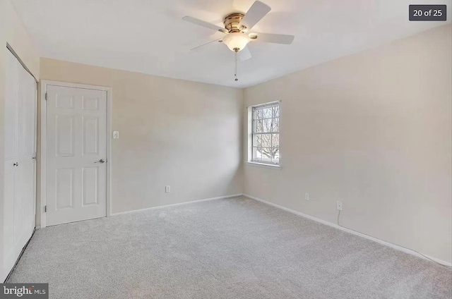 unfurnished room with carpet flooring, a ceiling fan, and baseboards