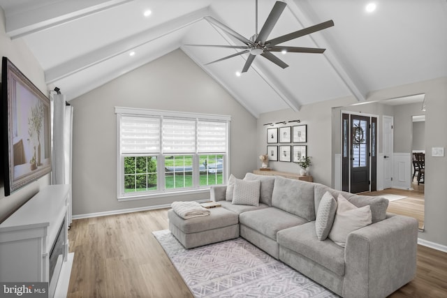living room featuring vaulted ceiling with beams, ceiling fan, and recessed lighting