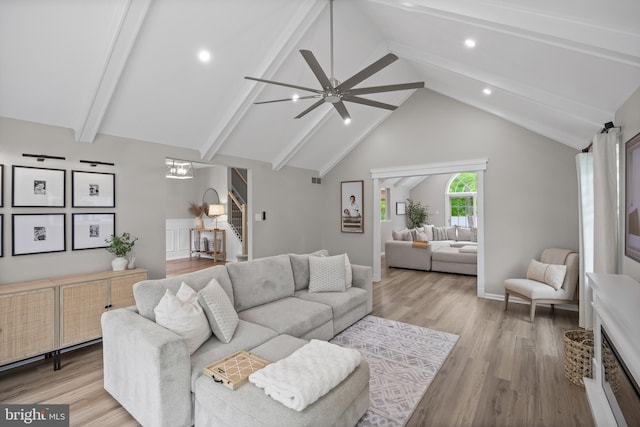 living room with a ceiling fan, beamed ceiling, light wood-style flooring, and recessed lighting