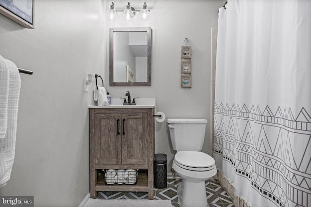 full bath featuring toilet, vanity, and curtained shower