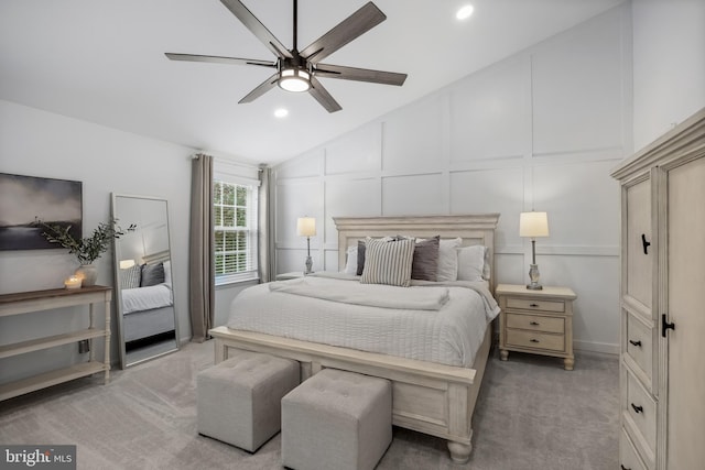 bedroom with recessed lighting, vaulted ceiling, a decorative wall, and carpet floors