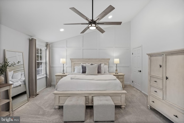 bedroom featuring vaulted ceiling, light colored carpet, a decorative wall, and recessed lighting
