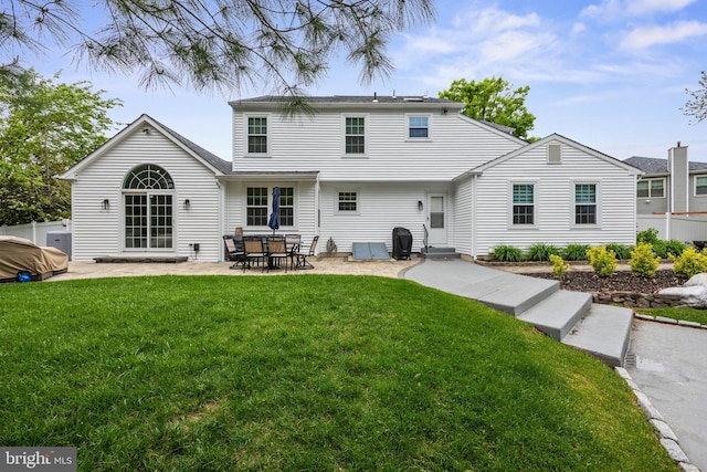 rear view of house with a yard and a patio area