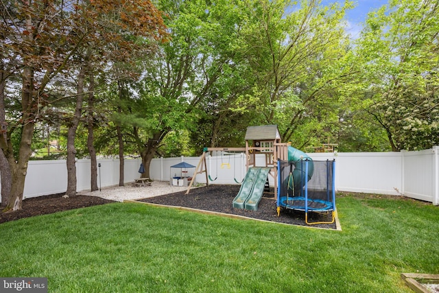 view of playground featuring a lawn and a fenced backyard