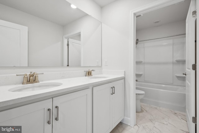 full bath with double vanity, a sink, marble finish floor, and toilet