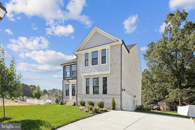 view of front facade with a garage, a front yard, driveway, and brick siding